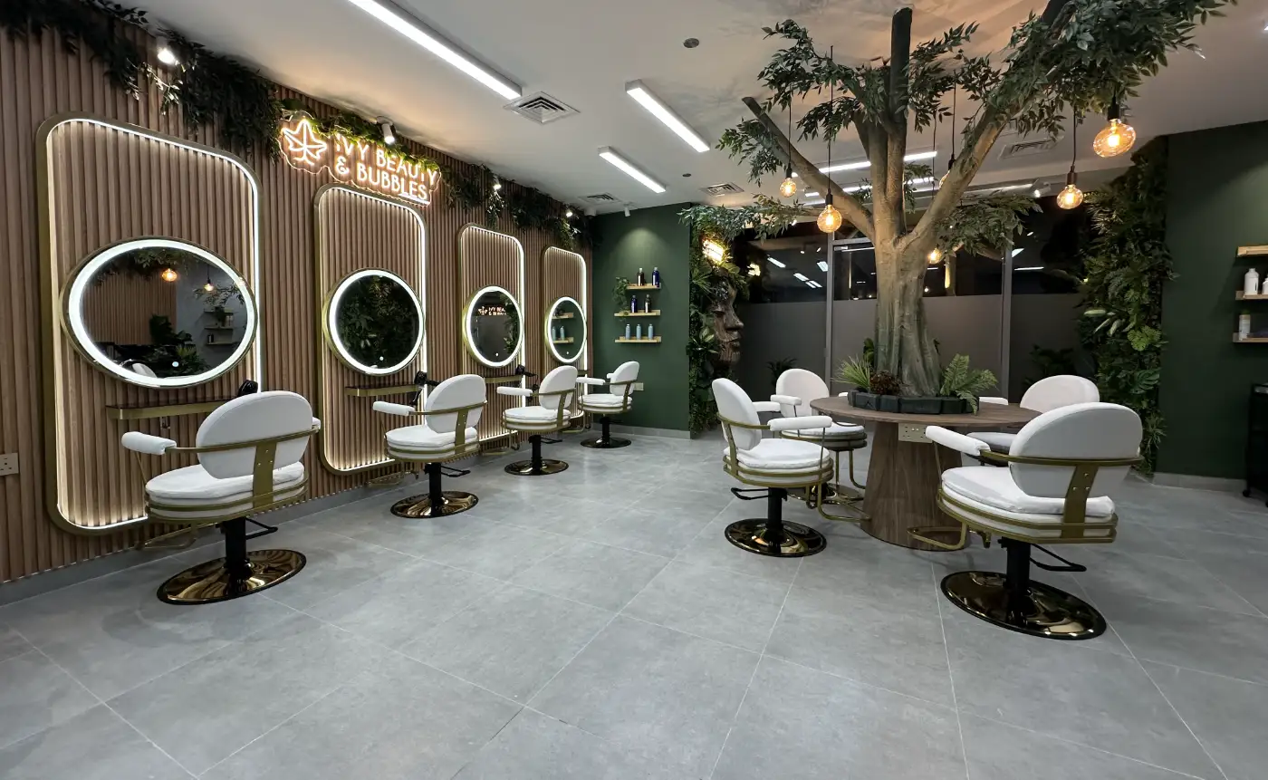 IVY Beauty & Bubbles hair salon in Dubai with illuminated arched mirrors and an indoor tree